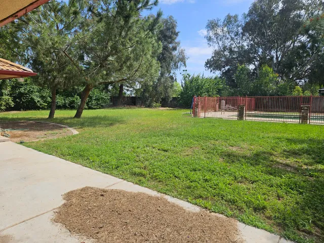 a backyard of a house with lots of green space