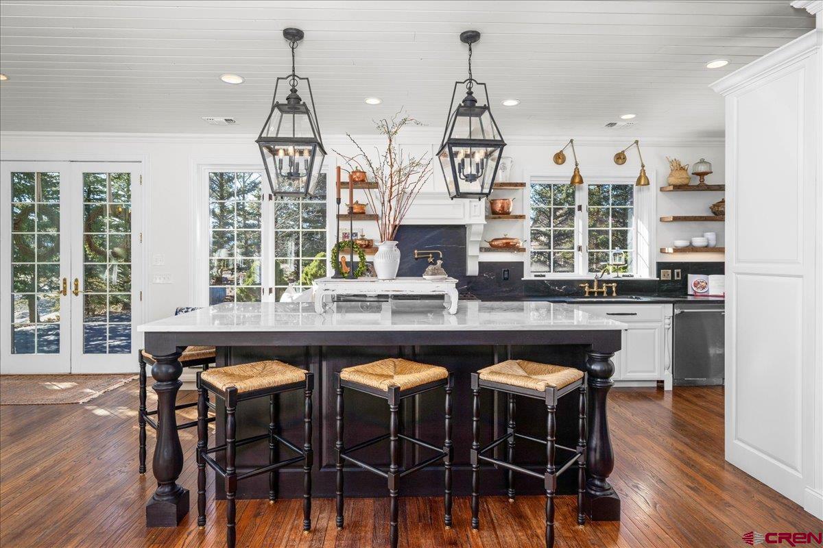 240 Vista Drive Ridgway, CO 81432 - Photo 14 of 41 a kitchen with a table chairs stove and wooden floor