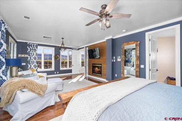 a spacious bedroom with a large bed and a chandelier