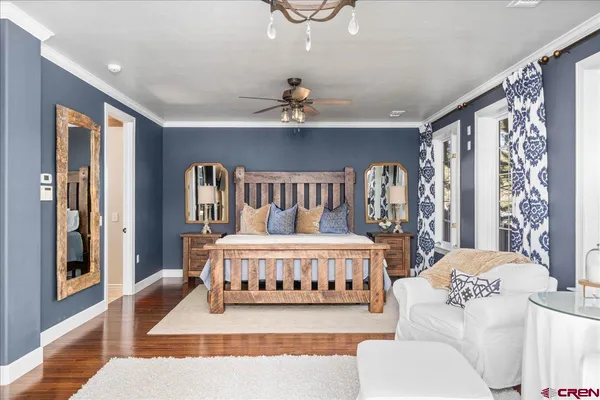 a bedroom with a bed lamp and a large window