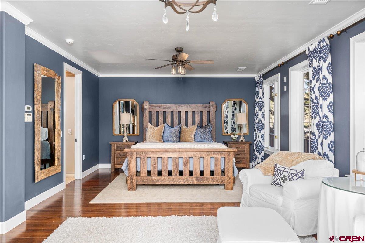 240 Vista Drive Ridgway, CO 81432 - Photo 20 of 41 a bedroom with a bed lamp and a large window