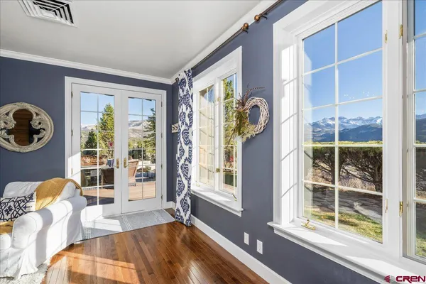 a bedroom with furniture and a large window