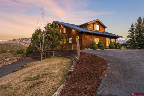a backyard of a house with table and chairs