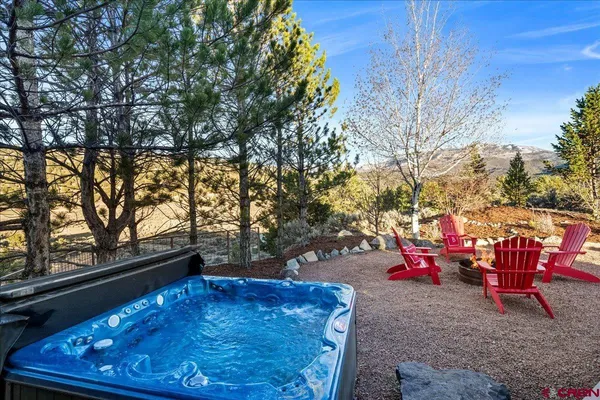 a backyard of a house with table and chairs
