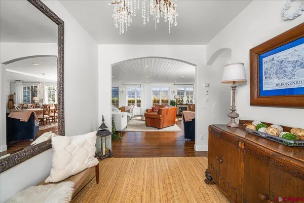 a living room with furniture and a chandelier