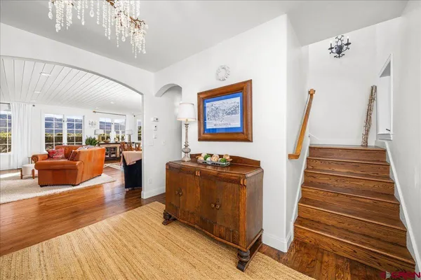 a living room with furniture and a chandelier