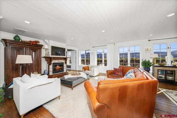 a living room with fireplace furniture and a fireplace