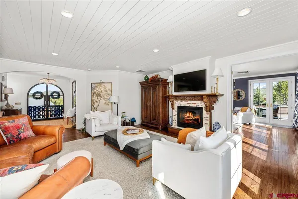 a living room with furniture a fireplace and a flat screen tv