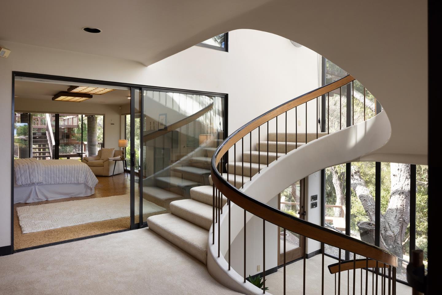 571 Viejo Road Carmel, CA 93923 - Photo 23 of 41 a view of staircase with lots of frames and a rug