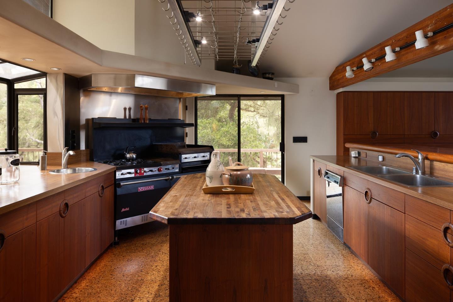 571 Viejo Road Carmel, CA 93923 - Photo 32 of 41 a kitchen with kitchen island granite countertop a sink stove and cabinets