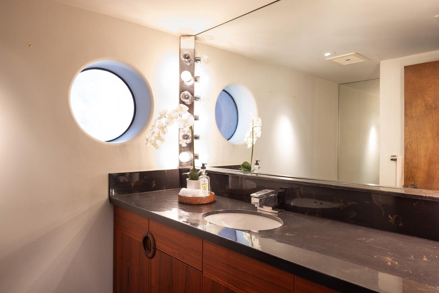 571 Viejo Road Carmel, CA 93923 - Photo 34 of 41 a bathroom with a double vanity sink and a mirror