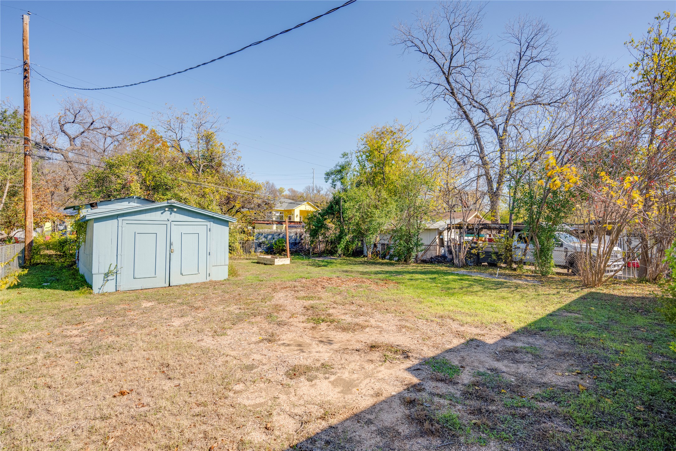 4804 Tanney Street Austin, TX 78721 - Photo 33 of 40 A detached storage shed anchors this sizable backyard, offering ample space for outdoor activities and landscaping projects.
