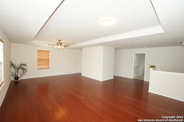 a view of empty room with wooden floor