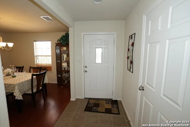 a view of a livingroom and a dining room with furniture window and wooden floor