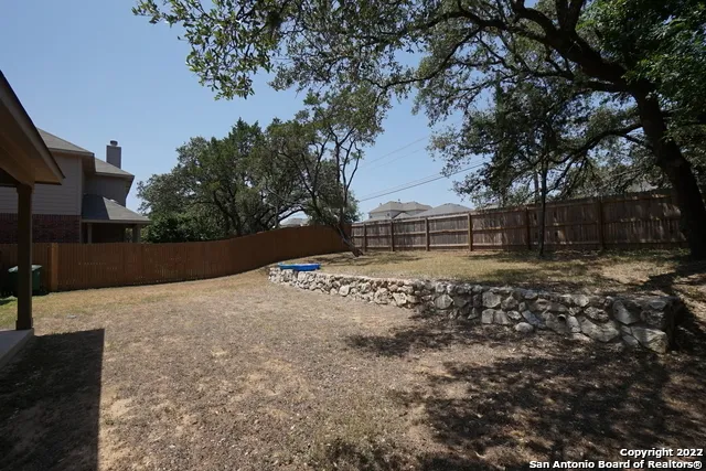 a backyard of a house with large trees