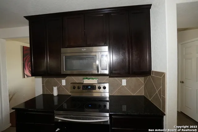 a kitchen with a stove and a microwave