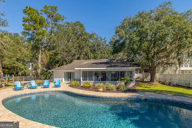 a living room with furniture a wooden floor and a bookshelf