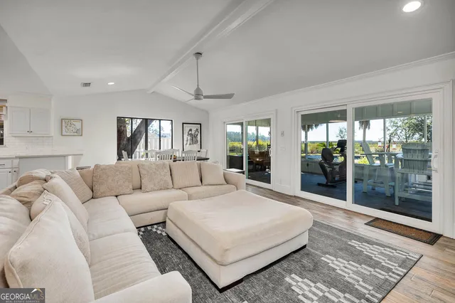 a dining room with furniture a rug and wooden floor