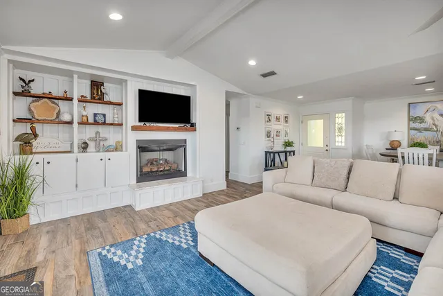 a kitchen with white cabinets white stainless steel appliances and window