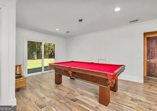 a view of a dining room with furniture large windows and wooden floor