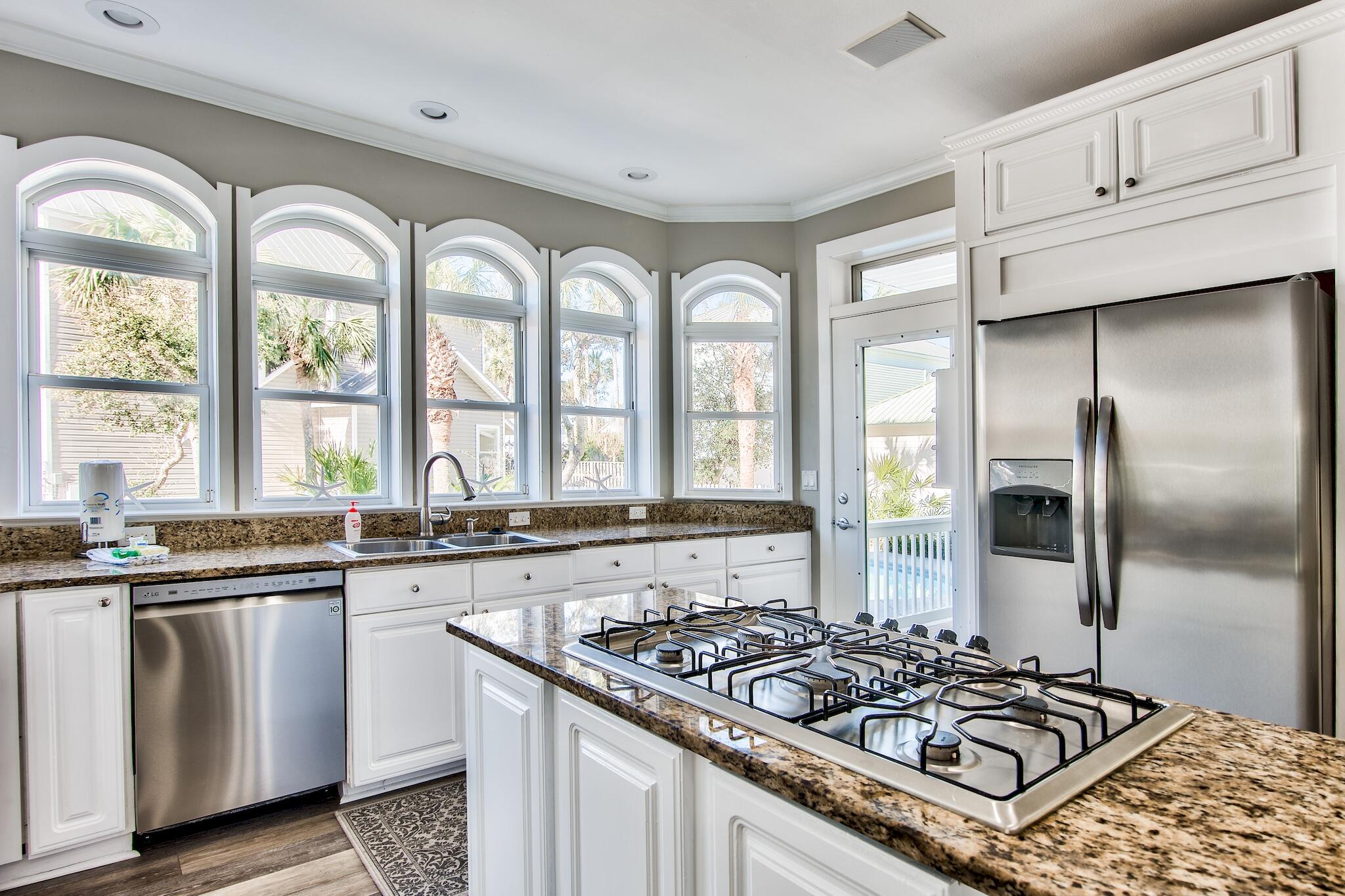 4489 Ocean View Drive Destin, FL 32541 - Photo 11 of 61 a kitchen with stainless steel appliances granite countertop a stove a sink and a refrigerator