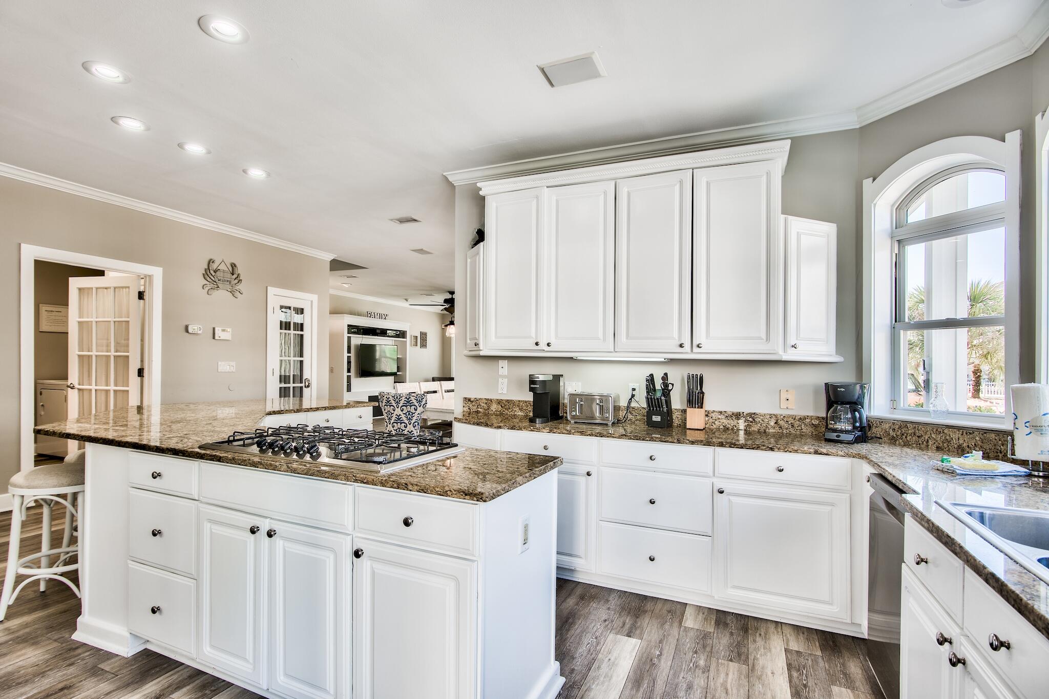 4489 Ocean View Drive Destin, FL 32541 - Photo 13 of 61 a kitchen with granite countertop white cabinets white appliances and sink