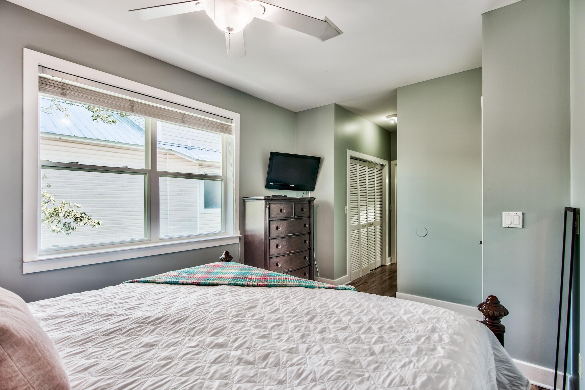 4489 Ocean View Drive Destin, FL 32541 - Photo 34 of 61 a bedroom with a bed and a flat tv screen next to a window