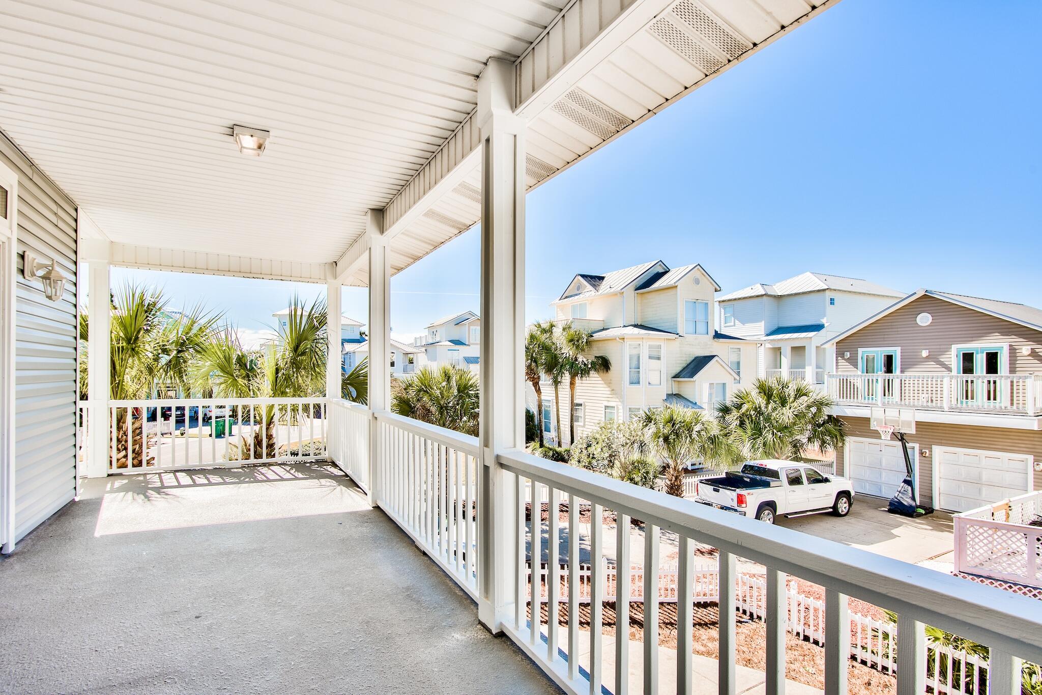 4489 Ocean View Drive Destin, FL 32541 - Photo 45 of 61 a view of a porch with a table and chairs