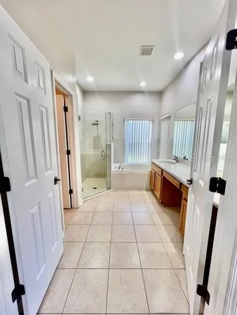 a bath room with a toilet a sink and a mirror