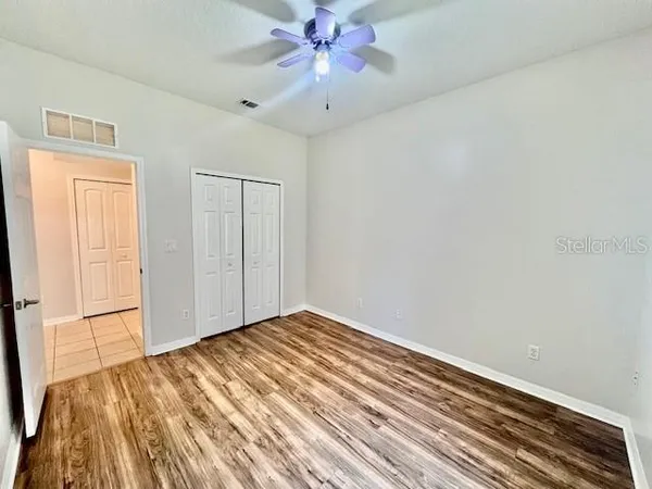a view of a dining room with furniture a chandelier and wooden floor