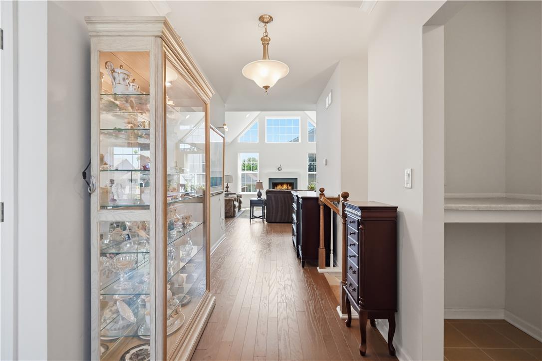 4120 Eveningstar Road Emmaus, PA 18049 - Photo 8 of 62 Enter into this luminous foyer, featuring rich hardwood floors leading to a spacious living area with a cozy fireplace and vaulted ceilings.