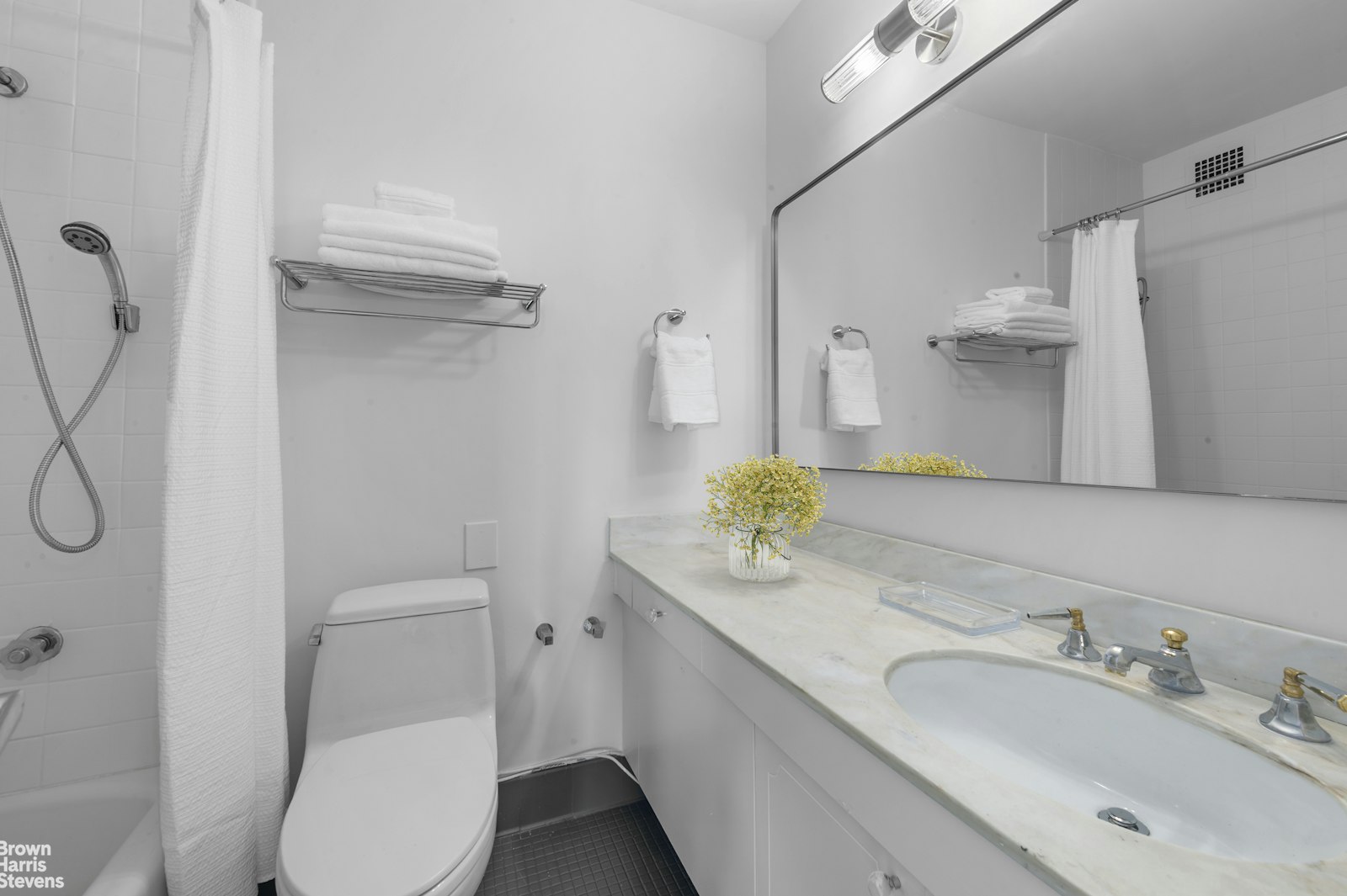 303 East 57th Street, Unit 39A Manhattan, NY 10022 - Photo 11 of 16 a bathroom with a granite countertop sink and a mirror