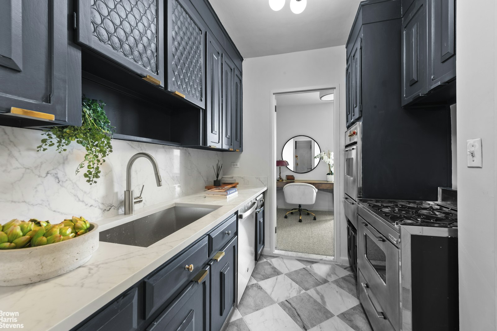 303 East 57th Street, Unit 39A Manhattan, NY 10022 - Photo 6 of 16 a kitchen with granite countertop a sink a stove and a microwave