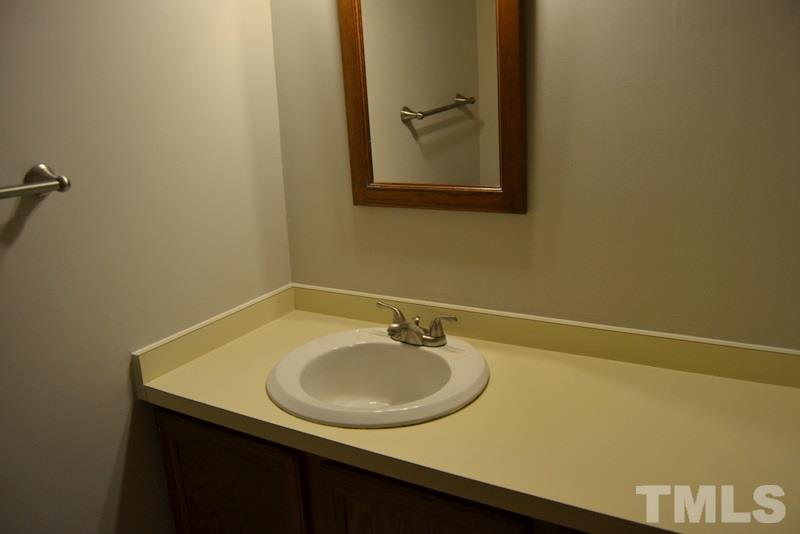 5204 Country Trail Raleigh, NC 27613 - Photo 14 of 23 a bathroom with a sink and a mirror