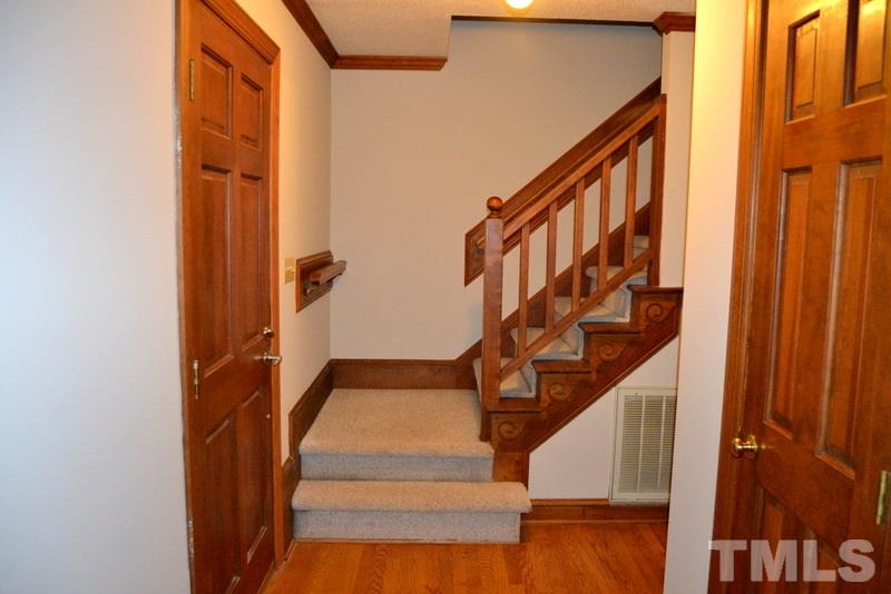 5204 Country Trail Raleigh, NC 27613 - Photo 5 of 23 a view of staircase with wooden floor and white walls