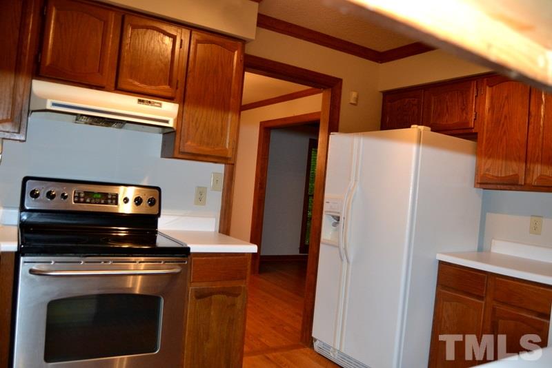 5204 Country Trail Raleigh, NC 27613 - Photo 8 of 23 a stove top oven sitting inside of a kitchen