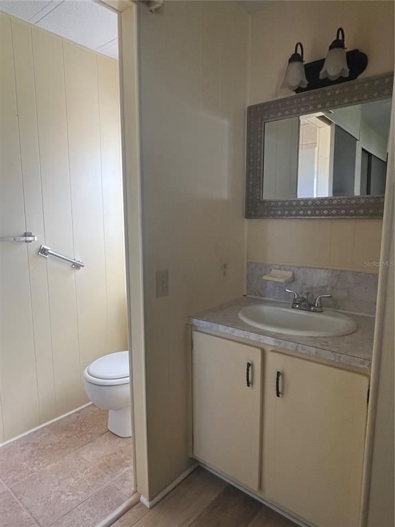 1100 South Belcher Road, Unit 185 Largo, FL 33771 - Photo 13 of 50 a bathroom with a granite countertop toilet sink and mirror