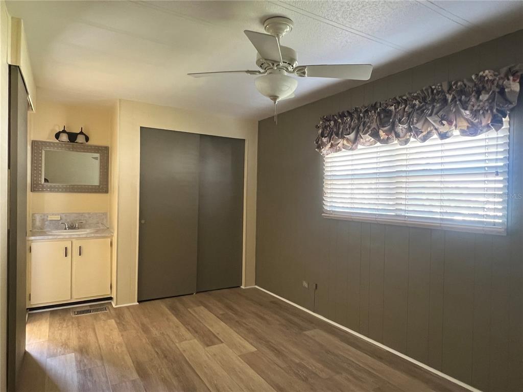 1100 South Belcher Road, Unit 185 Largo, FL 33771 - Photo 14 of 50 a view of an empty room with wooden floor and a window