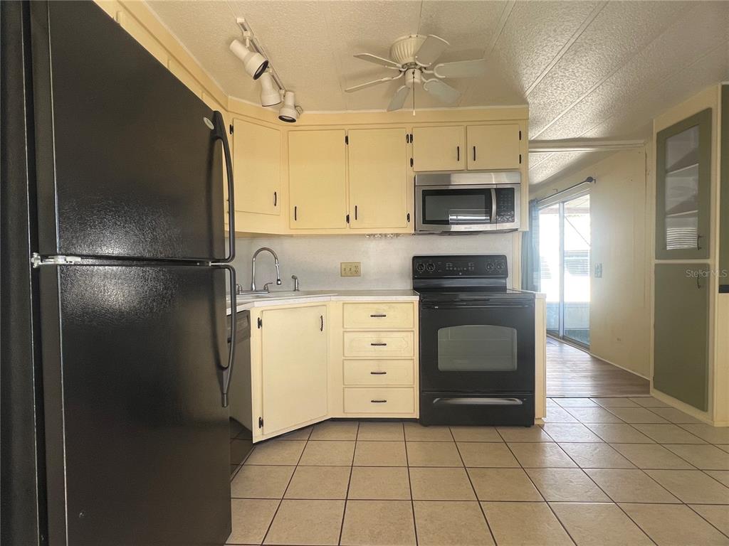 1100 South Belcher Road, Unit 185 Largo, FL 33771 - Photo 4 of 50 a kitchen with a refrigerator and a stove top oven