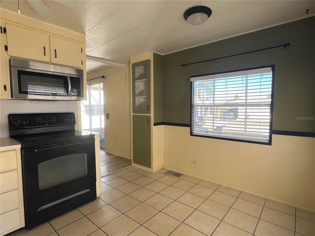 1100 South Belcher Road, Unit 185 Largo, FL 33771 - Photo 5 of 50 a kitchen with granite countertop cabinets appliances and a window