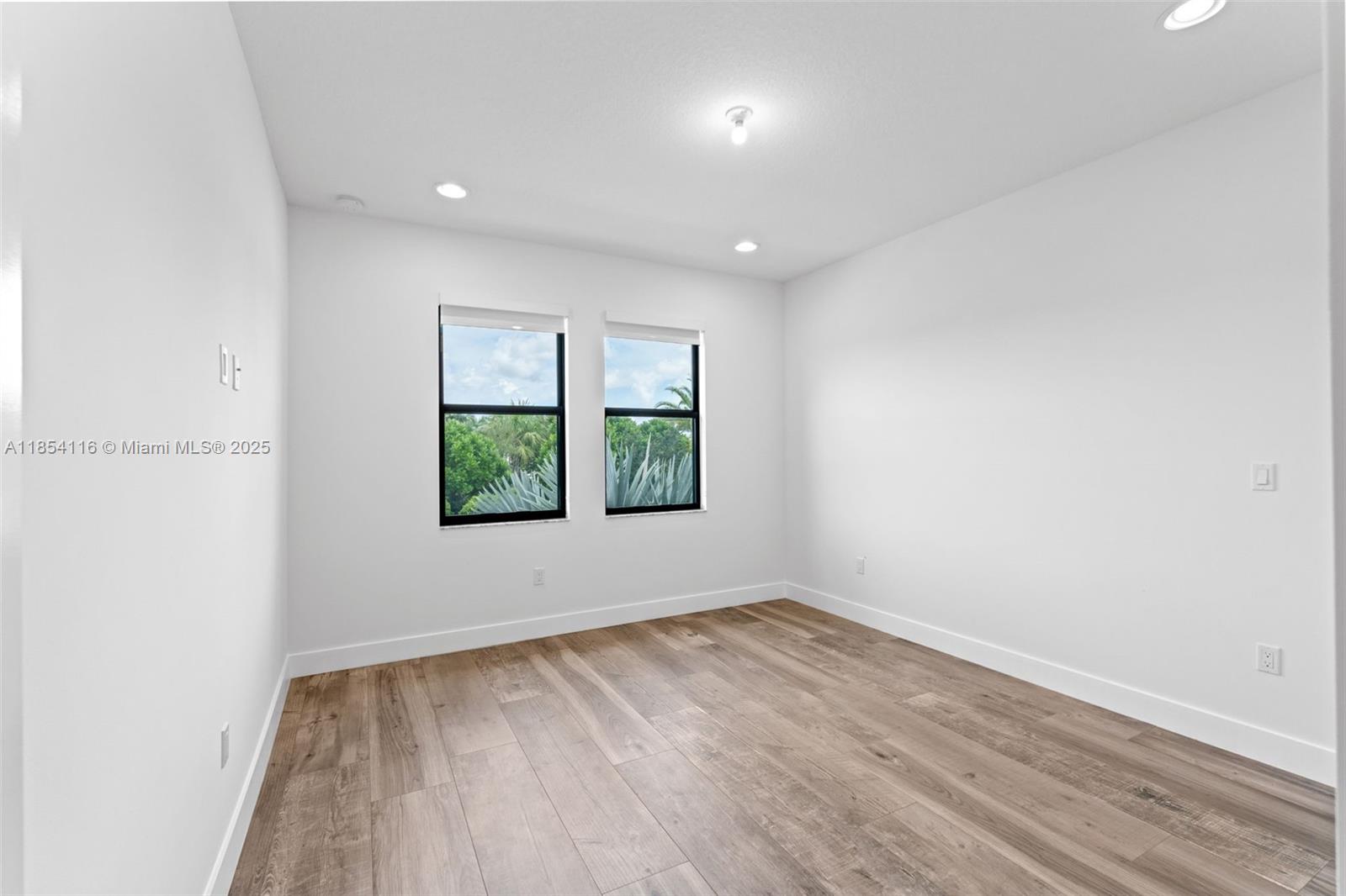 17117 Teton River Road Boca Raton, FL 33496 - Photo 26 of 77 an empty room with wooden floor and window