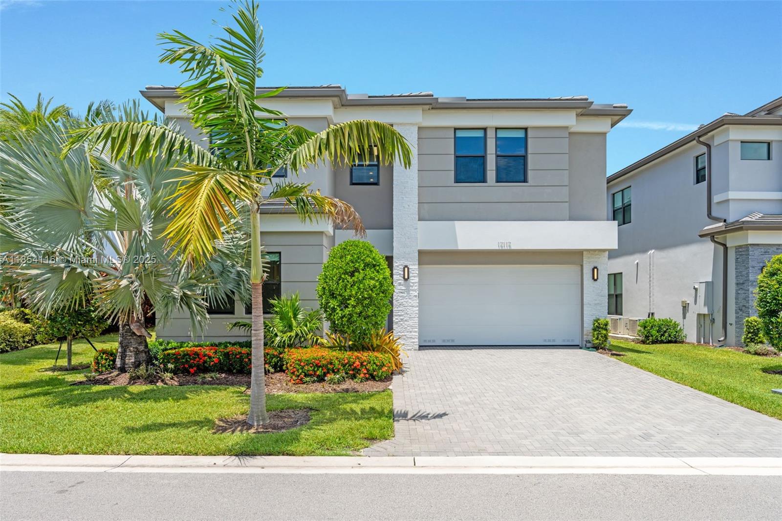 17117 Teton River Road Boca Raton, FL 33496 - Photo 6 of 77 a front view of a house with a garden and trees