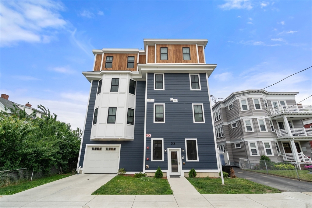 32 Pearl Street, Unit 4 Boston, MA 02125 - Photo 1 of 35 a front view of a house with a yard