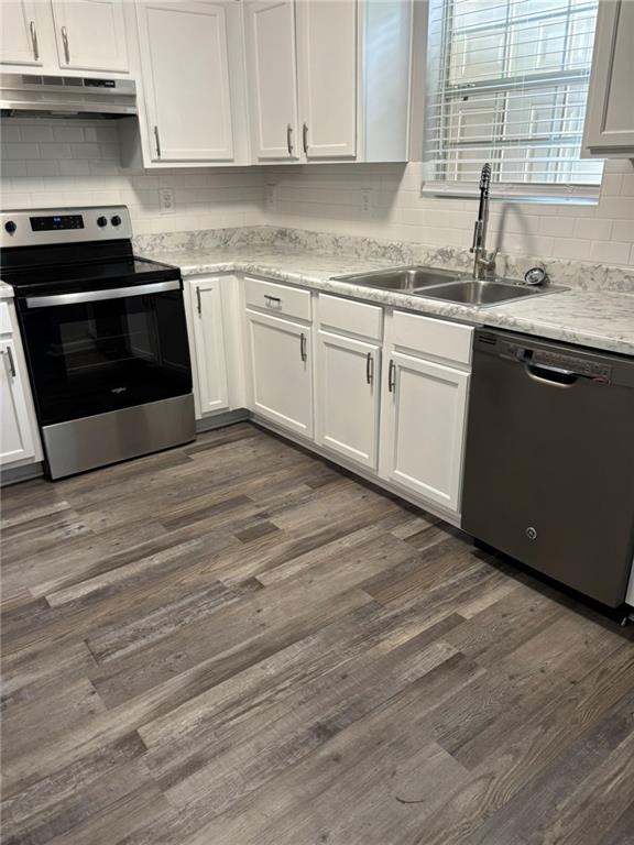5739 Windfall Lane Lithonia, GA 30058 - Photo 12 of 36 a kitchen with granite countertop wooden cabinets and a stove