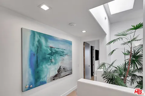 a bedroom with a bed and a potted plant