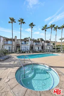 a front view of a house with a garden and patio