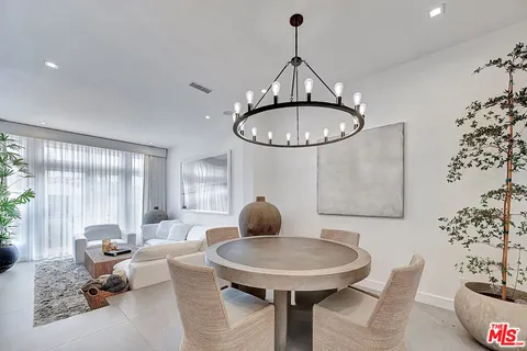 a room with furniture a chandelier and a large window