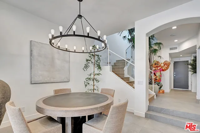 a view of a dining room with furniture and a chandelier