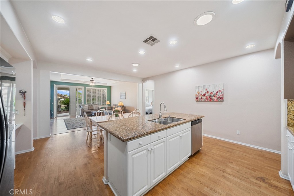 28713 Raintree Drive Menifee, CA 92584 - Photo 13 of 56 a kitchen with a counter top space a sink appliances and wooden floor