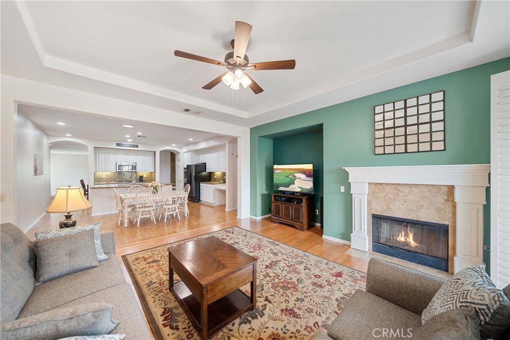 28713 Raintree Drive Menifee, CA 92584 - Photo 15 of 56 a living room with furniture a fireplace and a flat screen tv